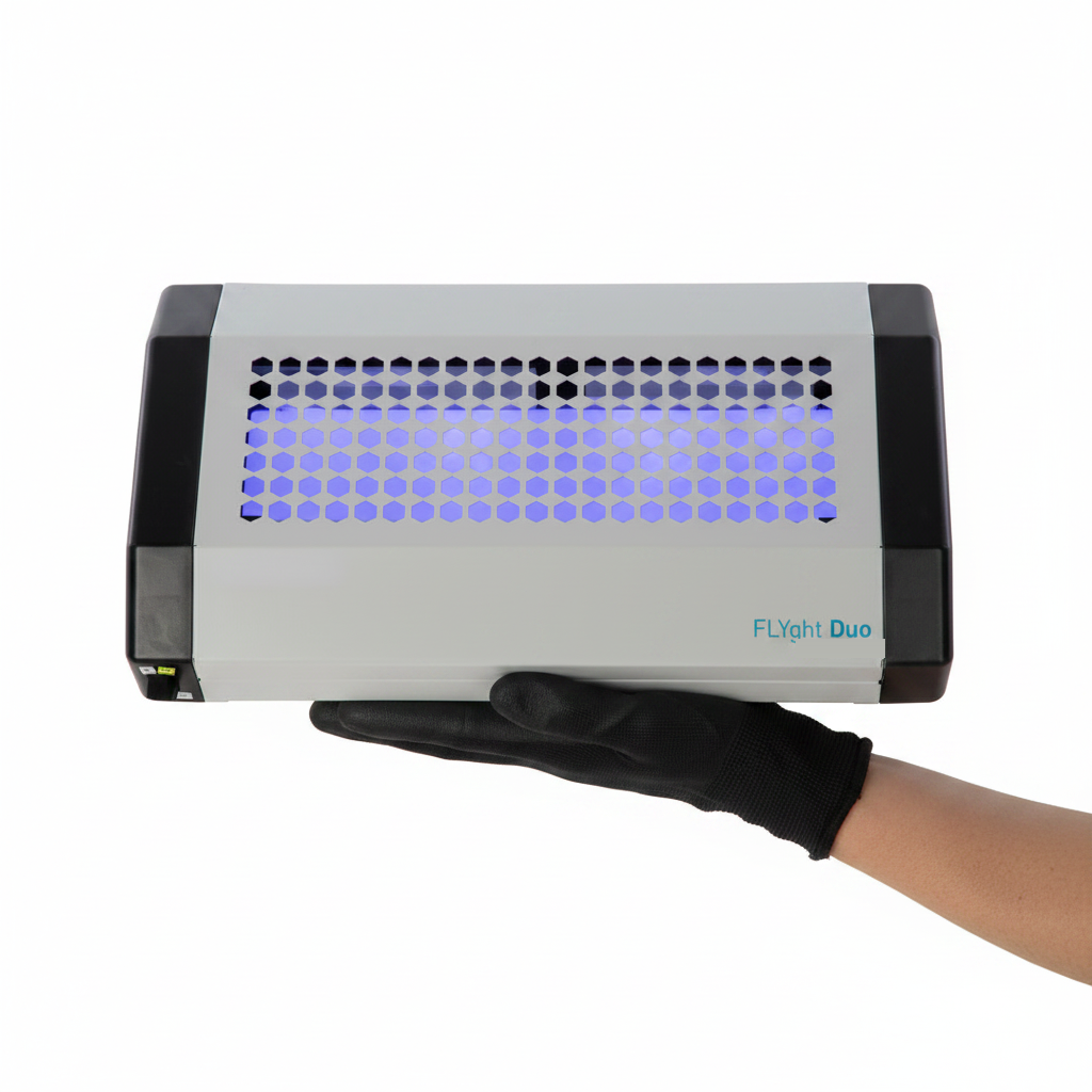 A gloved hand carrying a FLYghtDuo unit in one hand