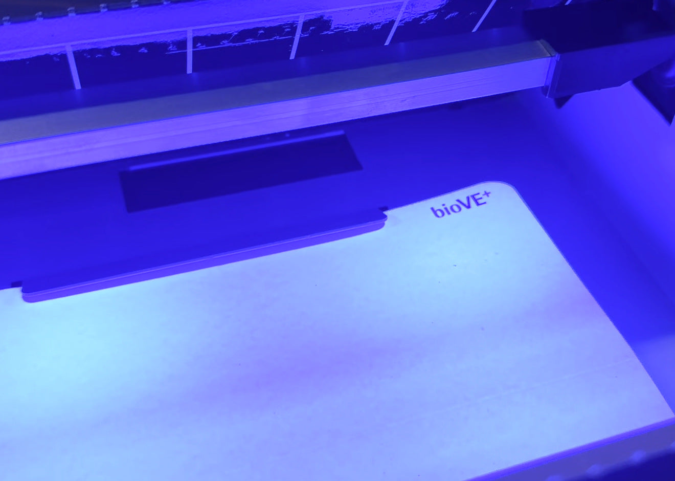 Close detail of the bioVE+ board lit by the UV LEDs